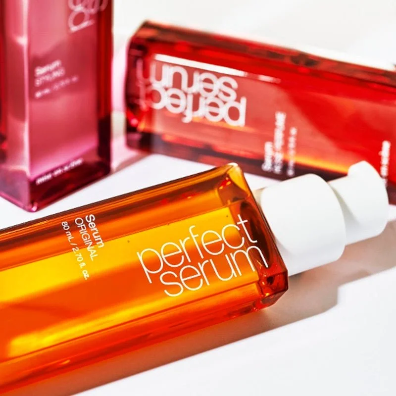 Ảnh bìa Facebook giới thiệu các chai serum dưỡng da màu cam đỏ nổi bật trên nền trắng